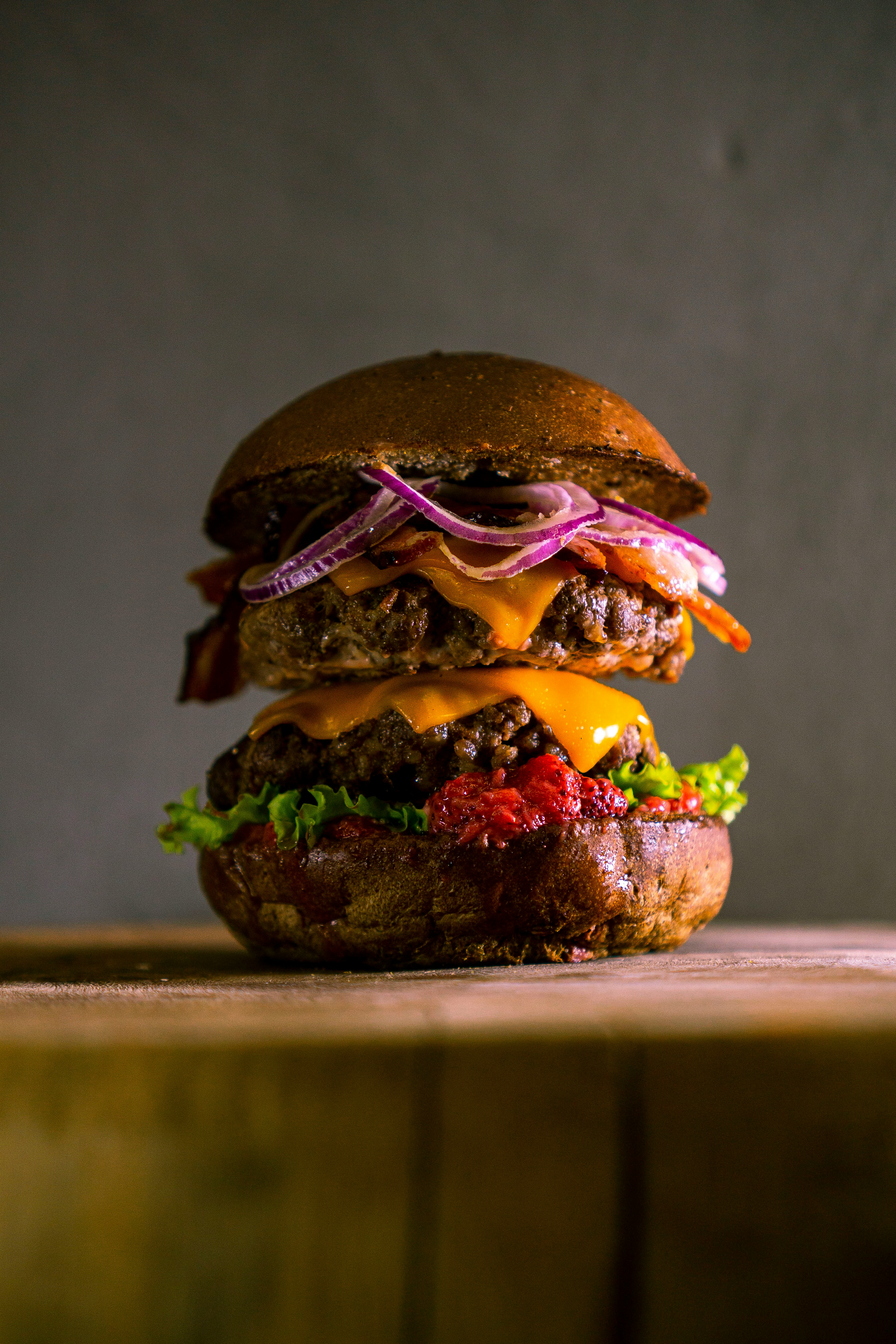 Signature beef burger with cheese, lettuce, tomato, and sauce